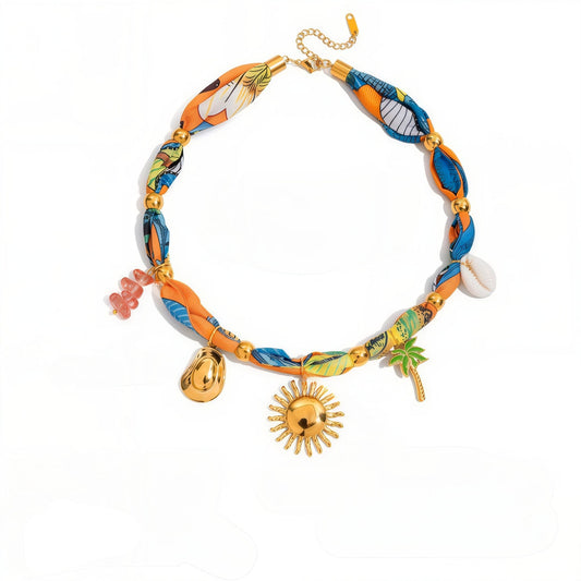 Colorful fabric choker necklace with gold-plated charms, including a sun, palm tree, and shell – perfect for summer beachwear.
