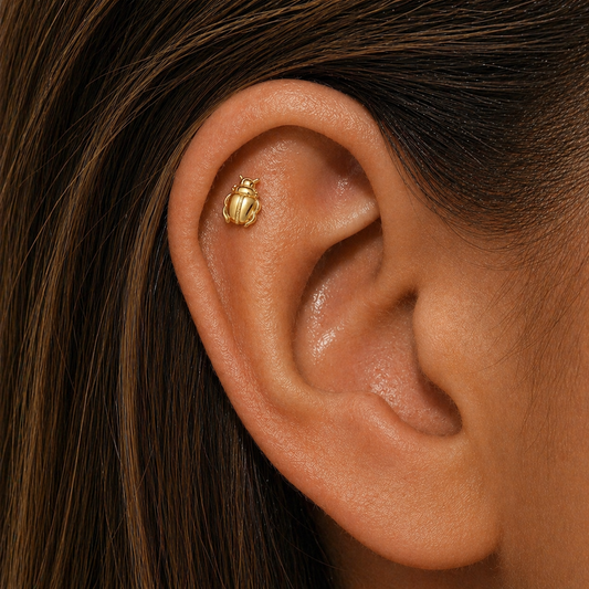 Gold scarab stud earring worn on helix cartilage piercing, minimalist insect jewelry