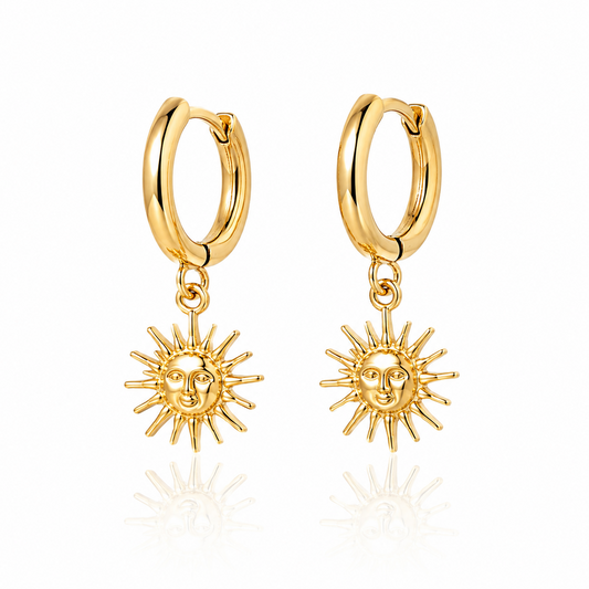 Pair of 18K gold plated sun hoop earrings with celestial charm on white background