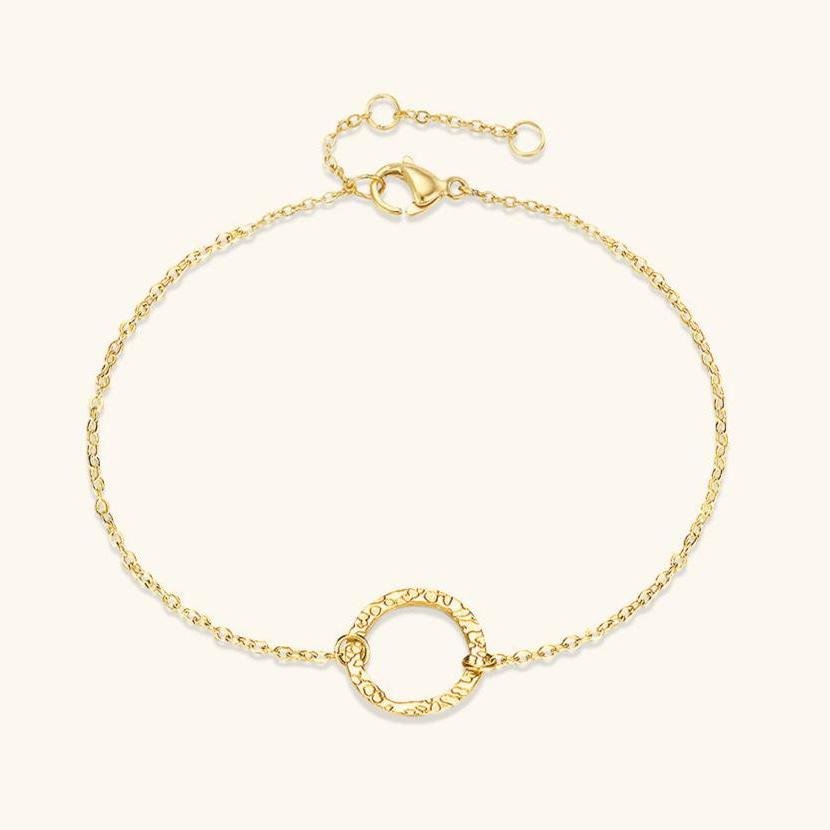 Delicate gold chain bracelet with a textured hoop centerpiece