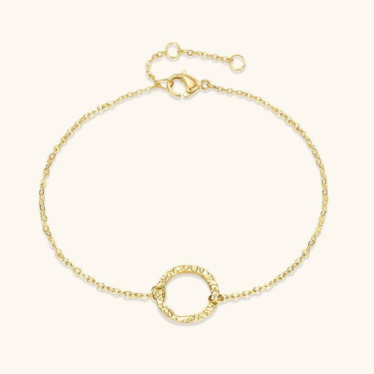Delicate gold chain bracelet with a textured hoop centerpiece