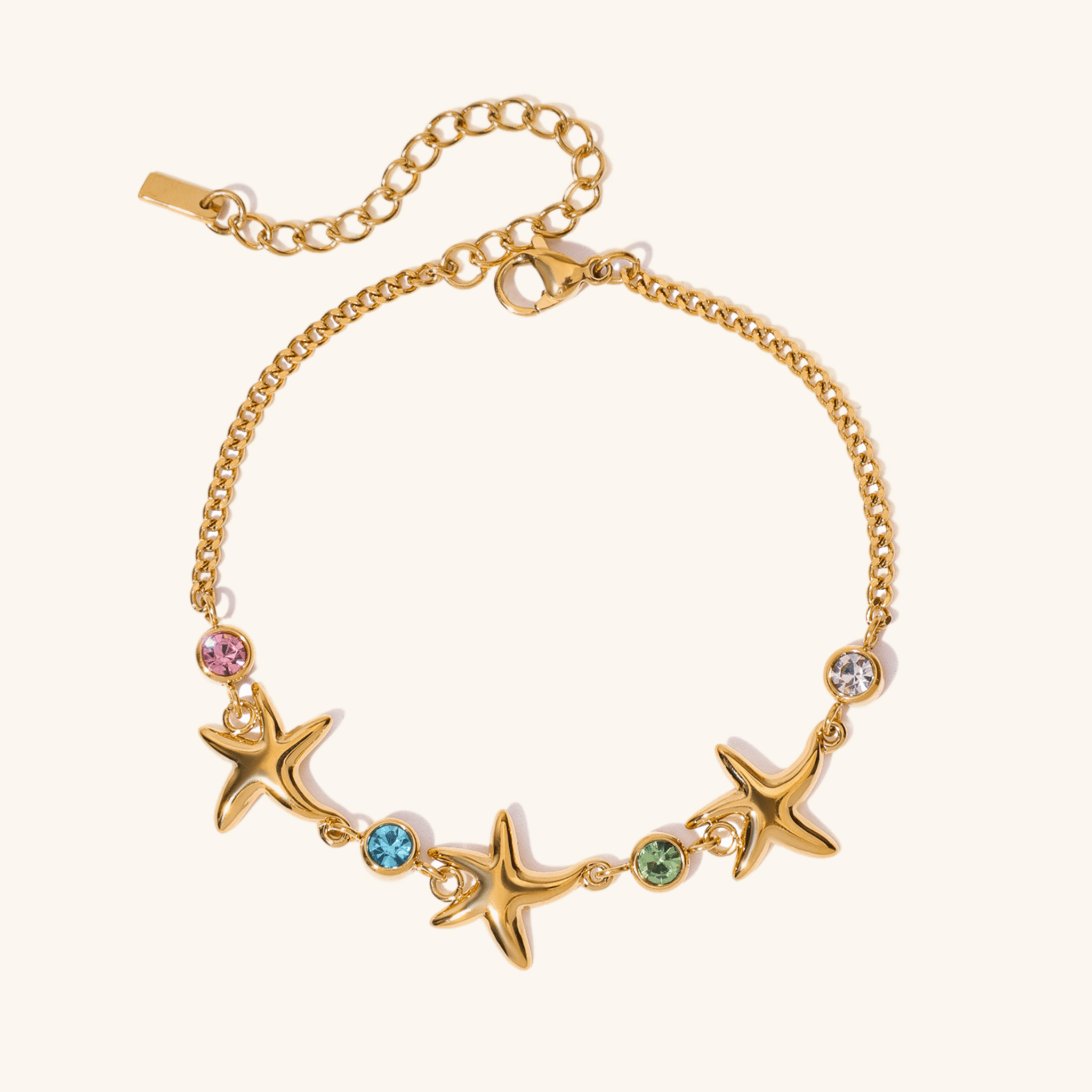 Ocean-inspired gold bracelet with colorful gems and starfish charms