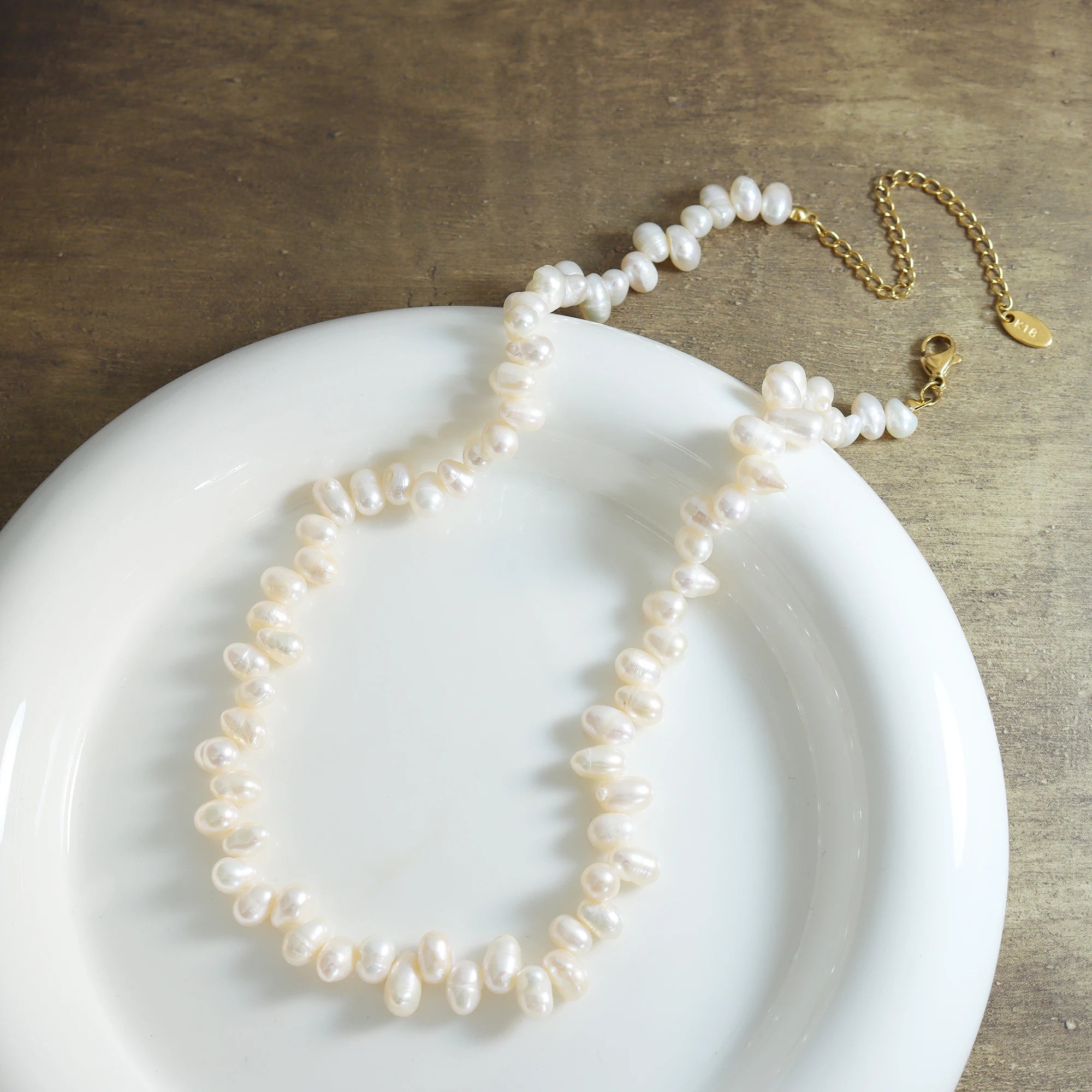 Baroque Pearl Choker displayed on a white ceramic plate for an aesthetic flatlay.