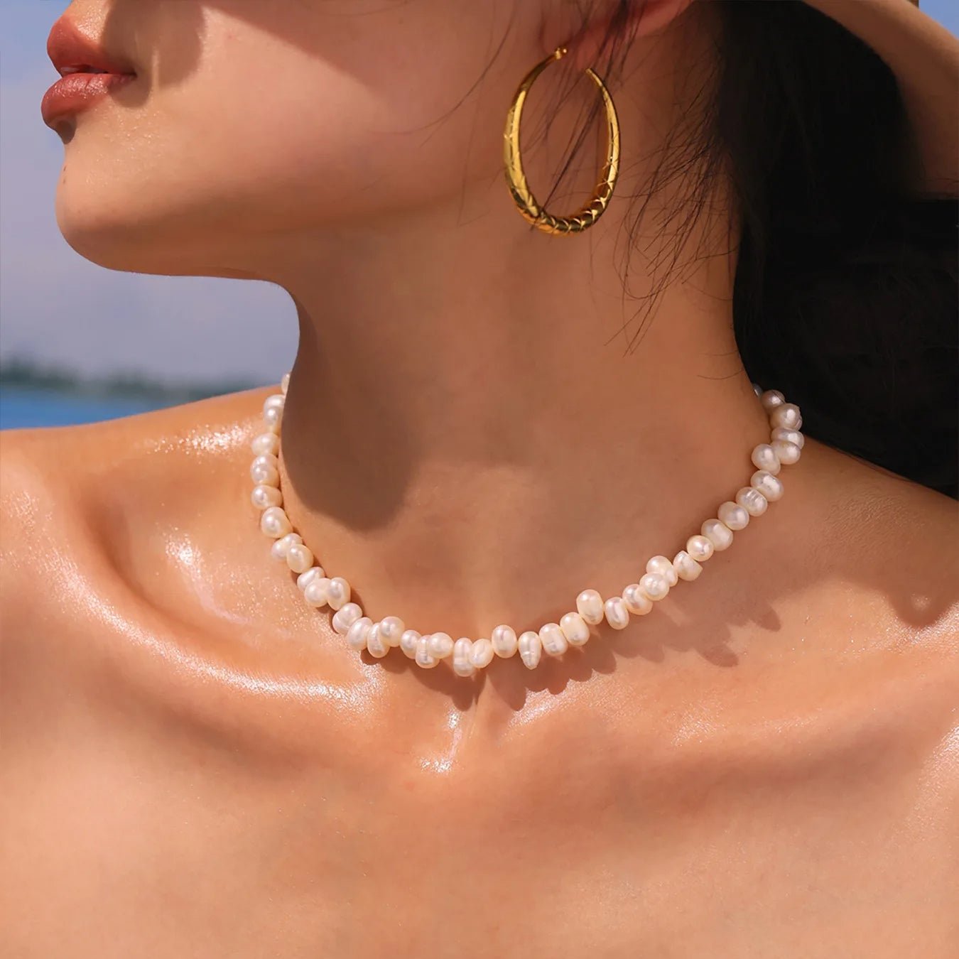 Side view of the Baroque Pearl Choker worn with gold earring, elegant summer styling.