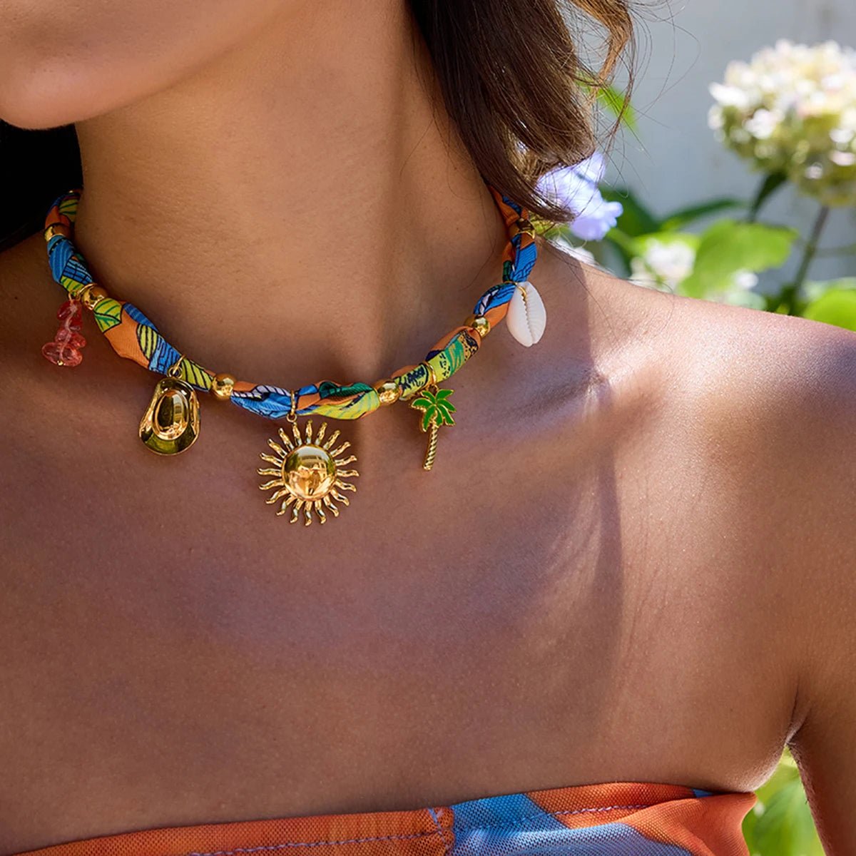 Boho-inspired fabric choker with colorful design and gold-plated charms, perfect for beach and resort wear.