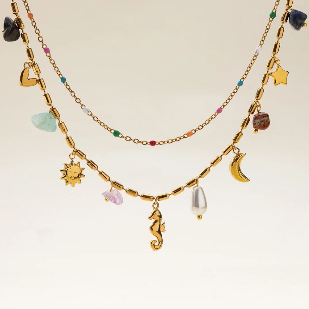 Summer layered gold charm necklace worn on model with bikini, beach jewelry