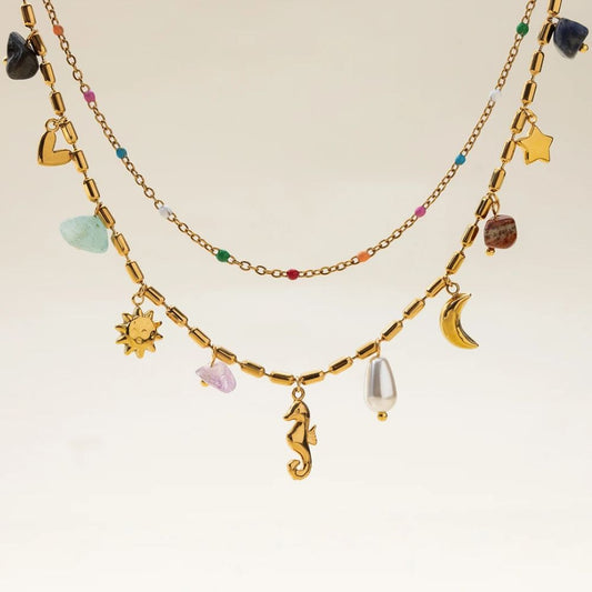 Layered gold charm necklace with colorful stones, beach jewelry style