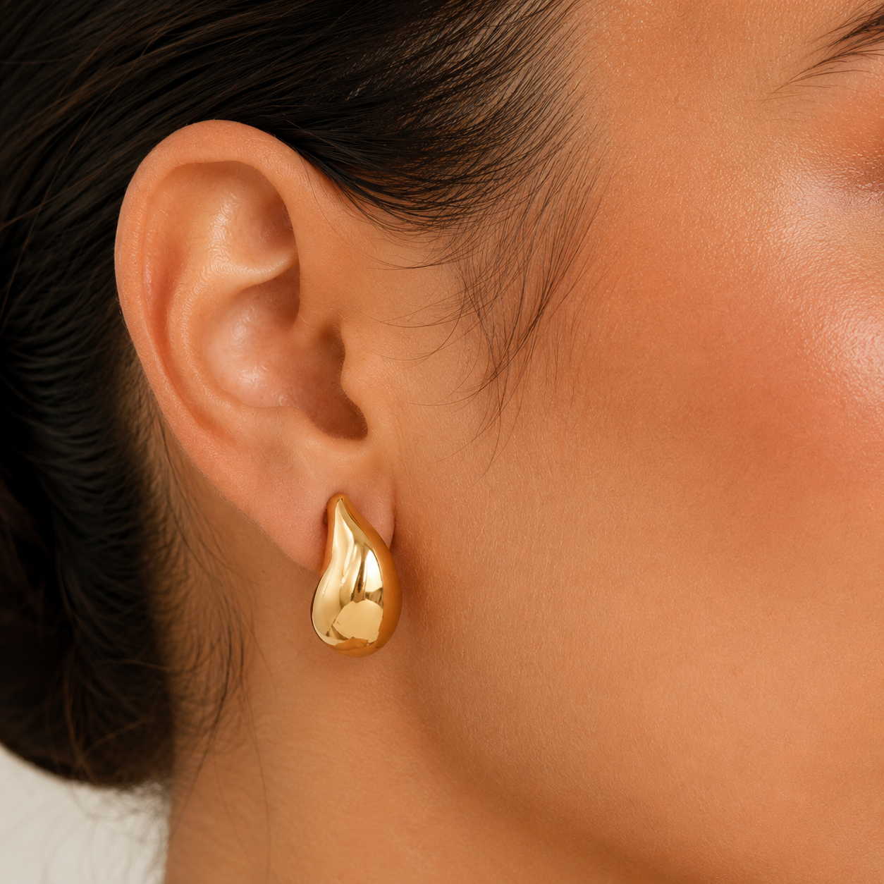 Gold teardrop stud earrings worn on ear, chunky gold earrings in waterproof 18K gold plated stainless steel