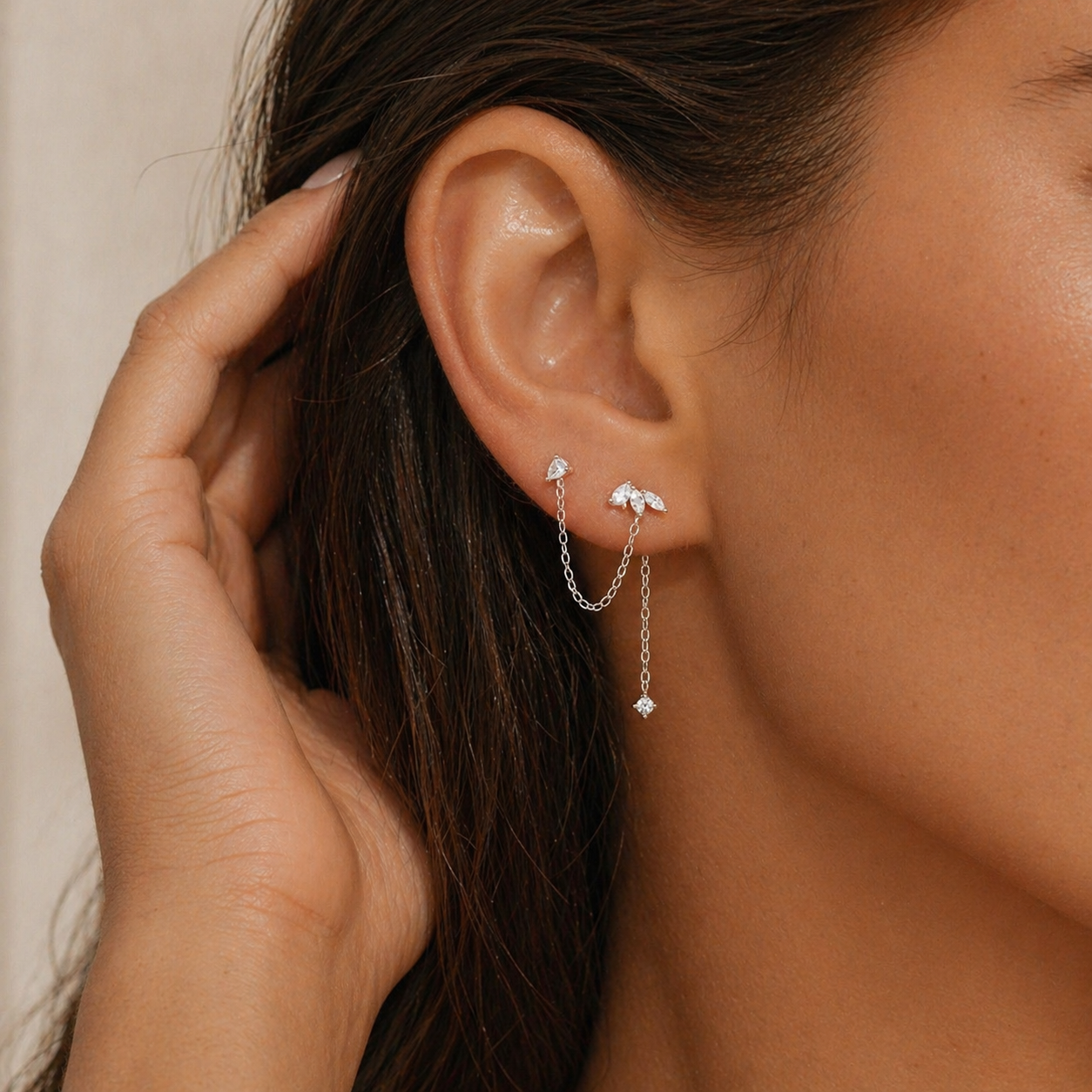 silver minimalist double piercing chain earrings on ear with soft natural styling