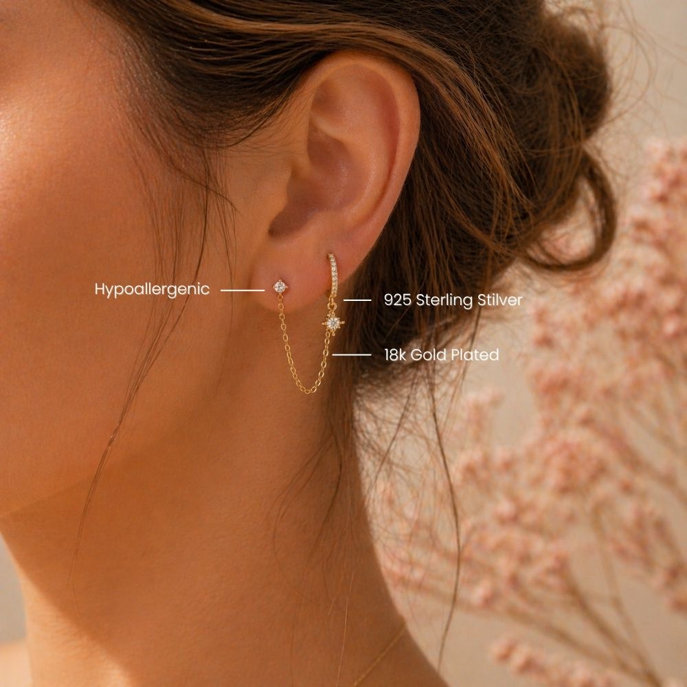 Double piercing chain pavé hoop earring in gold worn on two lobe piercings with CZ stud and hoop