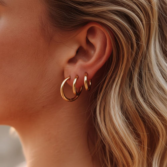 Essential hoop earrings worn on ear by blonde model in a minimal look