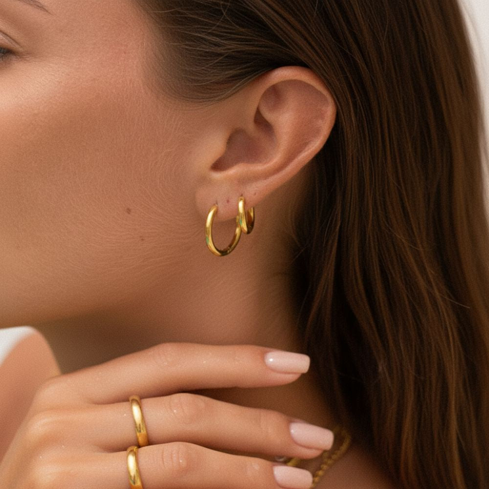 Essential hoop earrings worn on ear showing gold plated finish