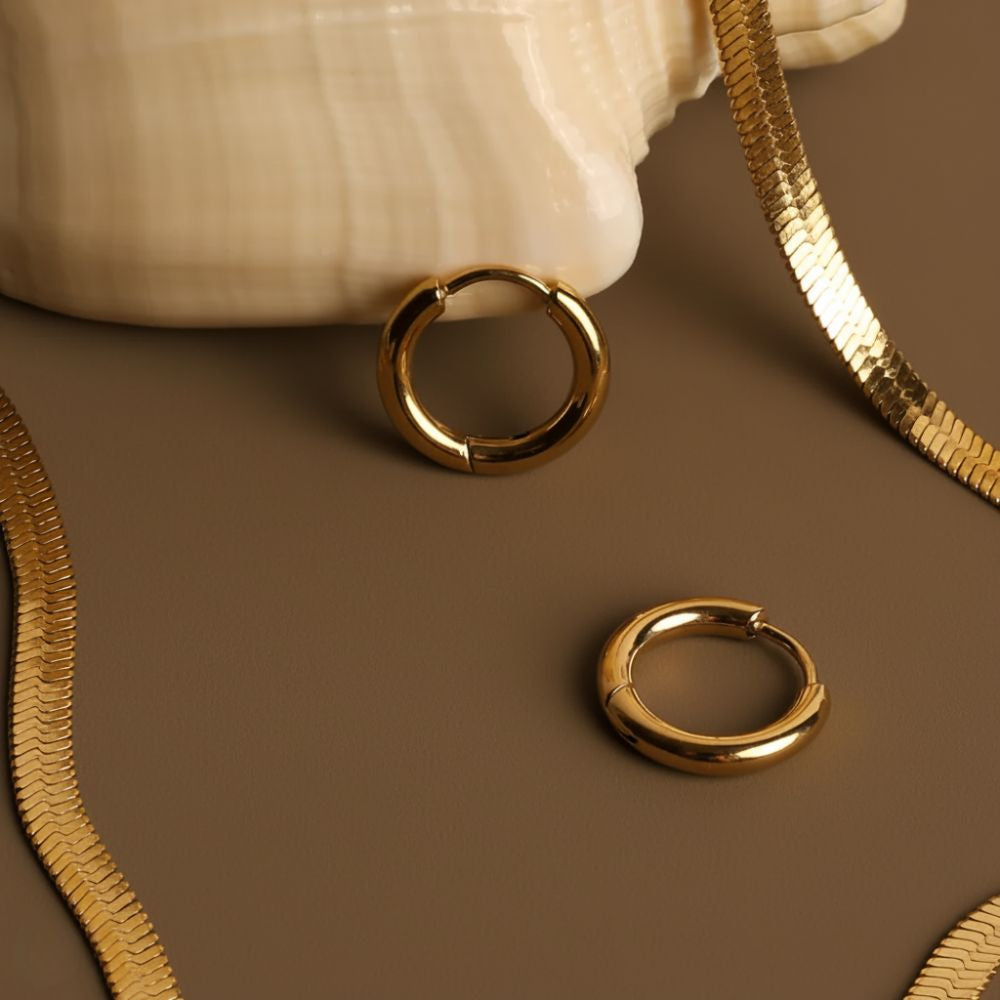 Essential hoop earrings displayed from a side angle highlighting smooth finish