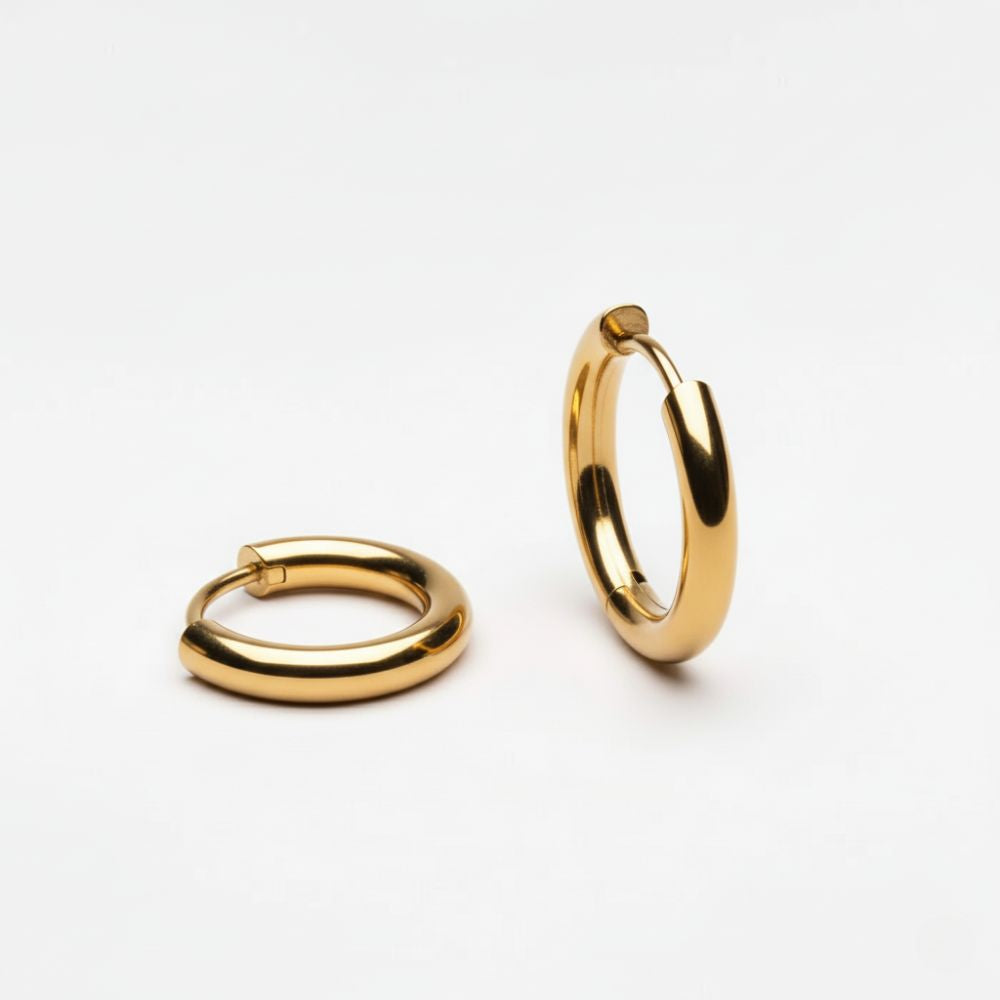 Essential gold hoop earrings in stainless steel, minimalist hoop earrings photographed on white background