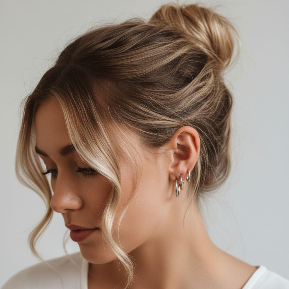 Essential hoop earrings in silver worn on ear with a minimalist studio look