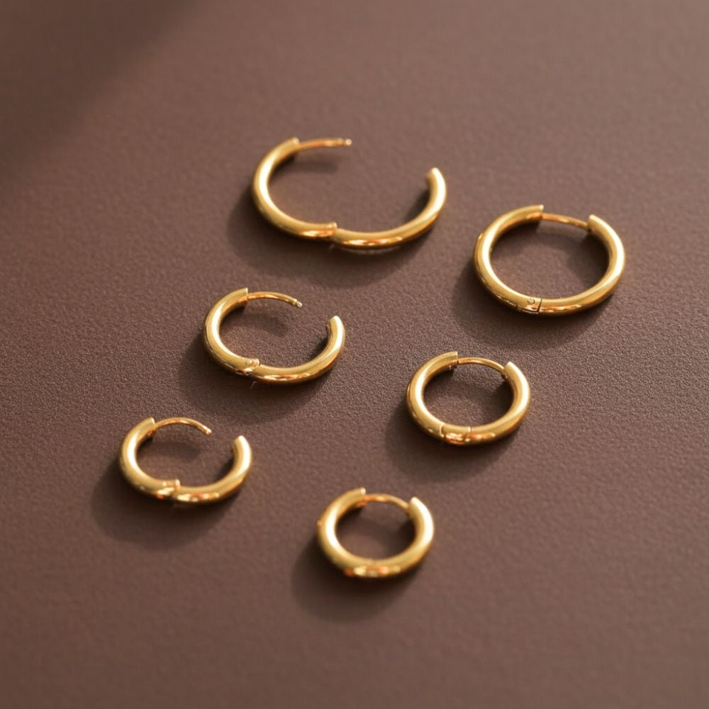 Gold essential hoop earrings trio bundle displayed open to show hoop sizes and shape