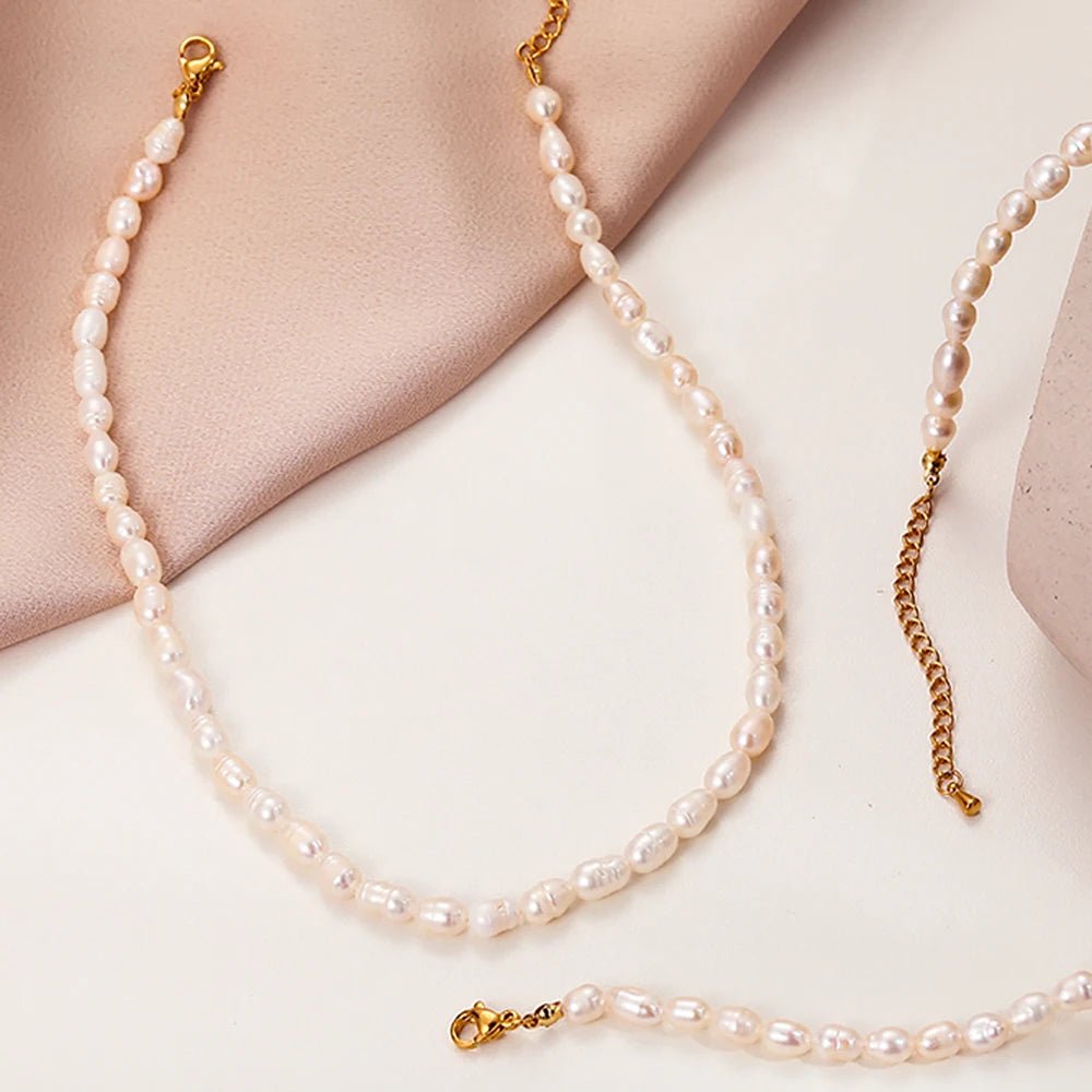 Flatlay of the Freshwater Pearl Choker and gold chain necklace on a neutral background.
