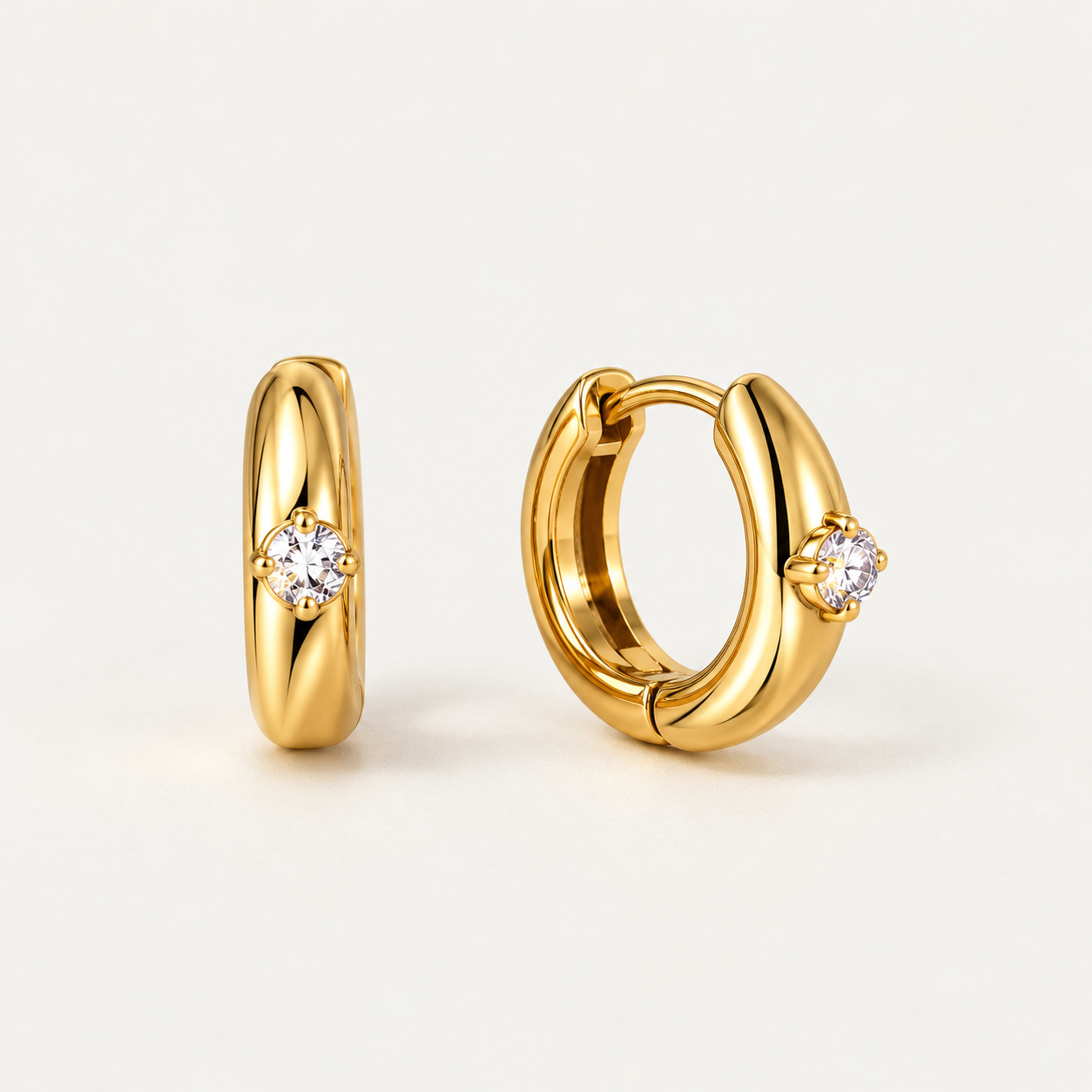 Chunky gold huggie hoop earrings with a single round white zircon stone, 18K gold plated waterproof stainless steel