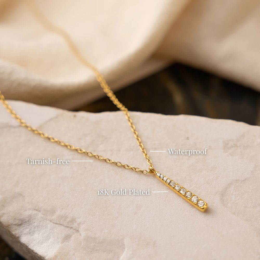 Close-up of a gold bar necklace in stainless steel, waterproof and non-tarnish minimalist pendant