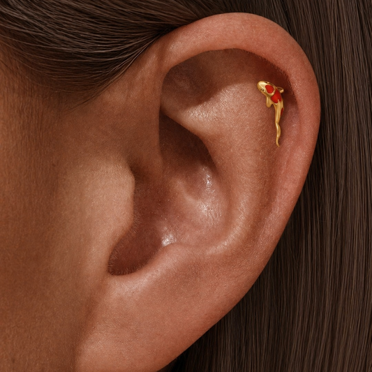Gold koi fish stud earring worn on helix piercing with red enamel, minimalist ear jewelry