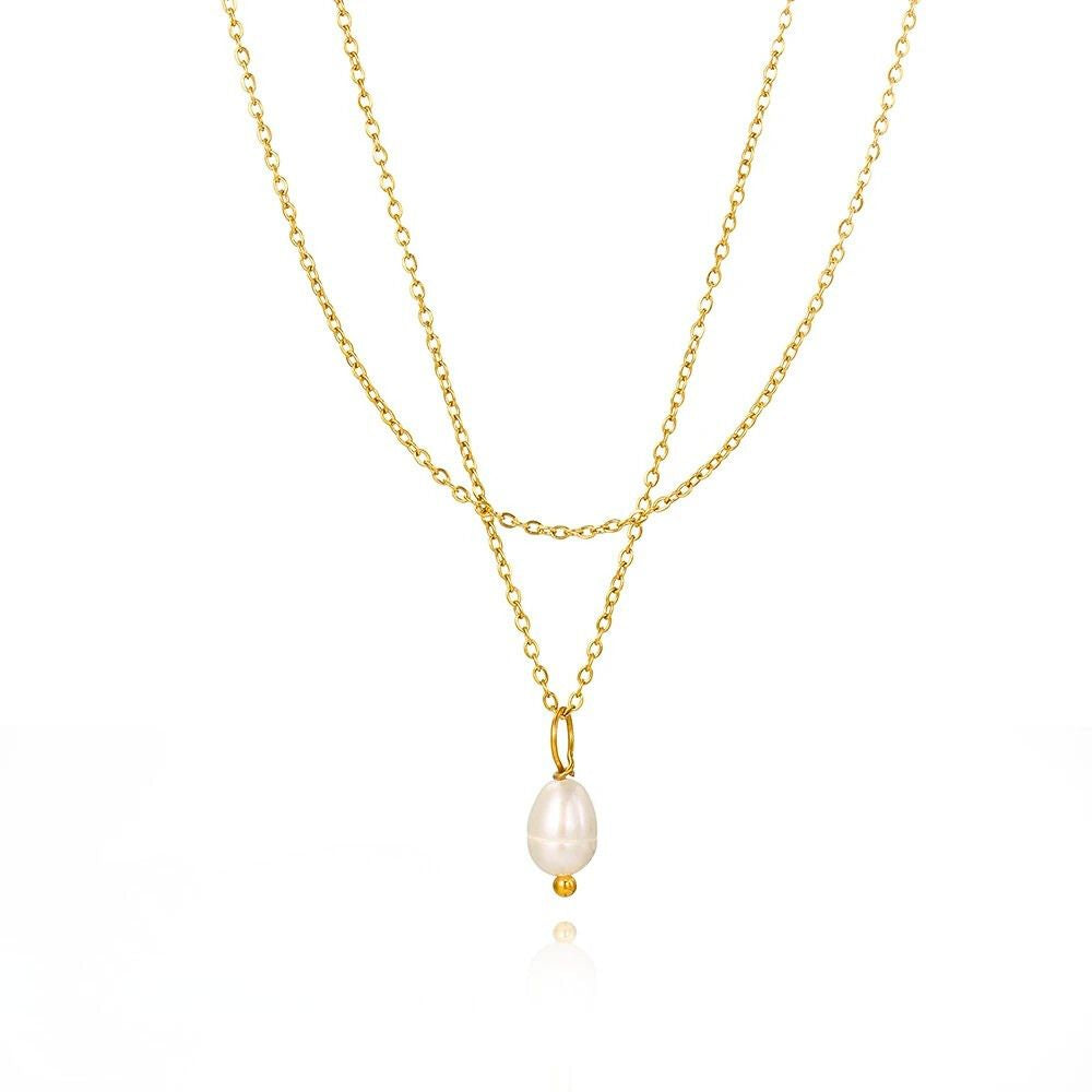 Gold layered necklace with a natural freshwater pearl pendant on white background.