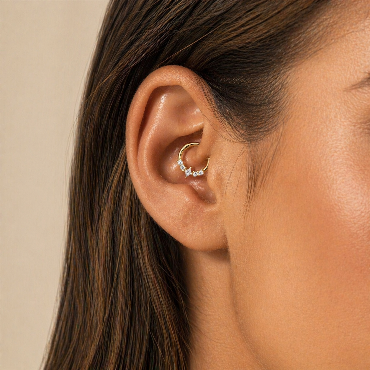 Gold marquise daith hoop earring worn in ear showing full ear styling and placement
