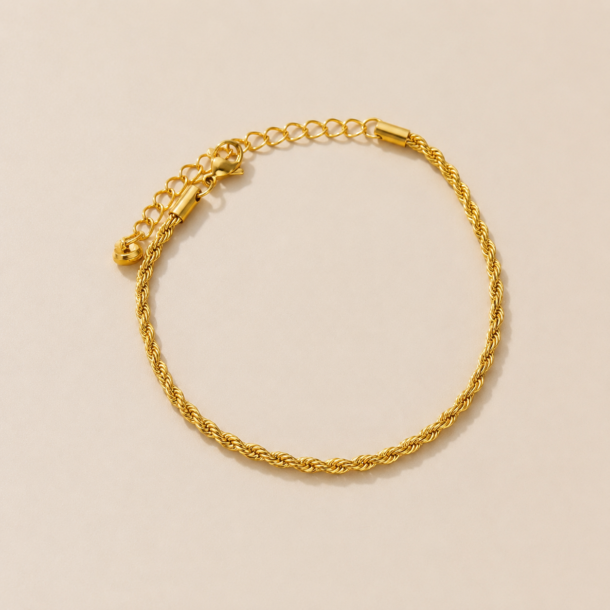 Gold rope chain anklet in stainless steel with twisted chain design displayed on a neutral background