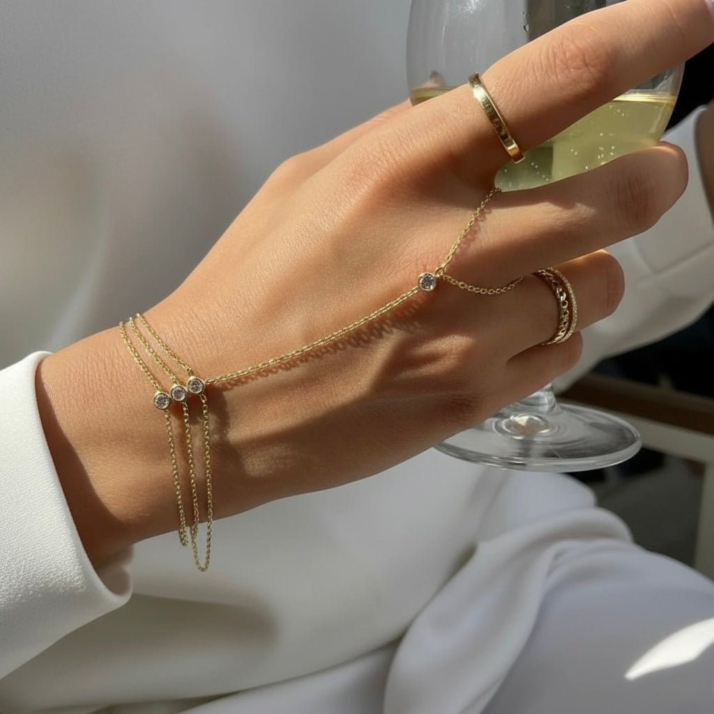 Close-up of the Gold Trio Hand Chain Bracelet worn on the hand, featuring three zircon stones and 18K gold-plated chains.