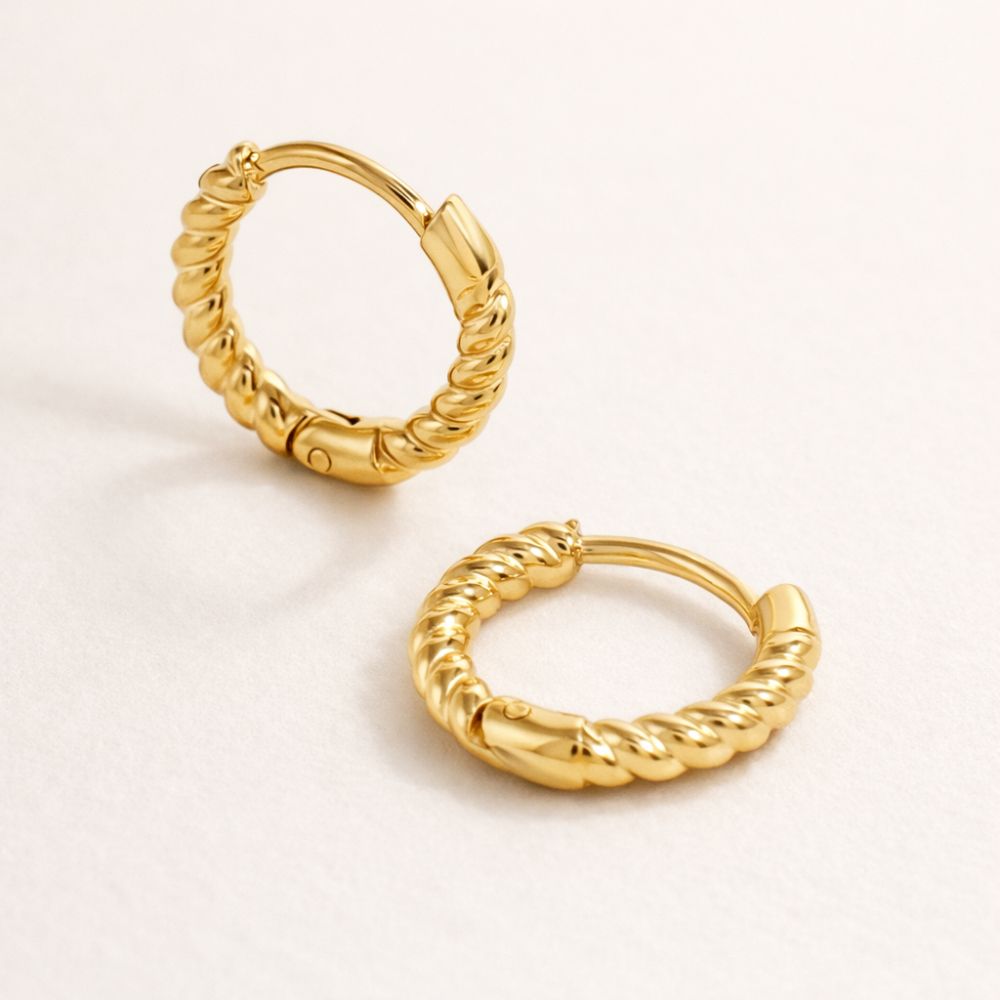 Gold twisted hoop earrings with rope texture, small huggie hoops in gold plated stainless steel.