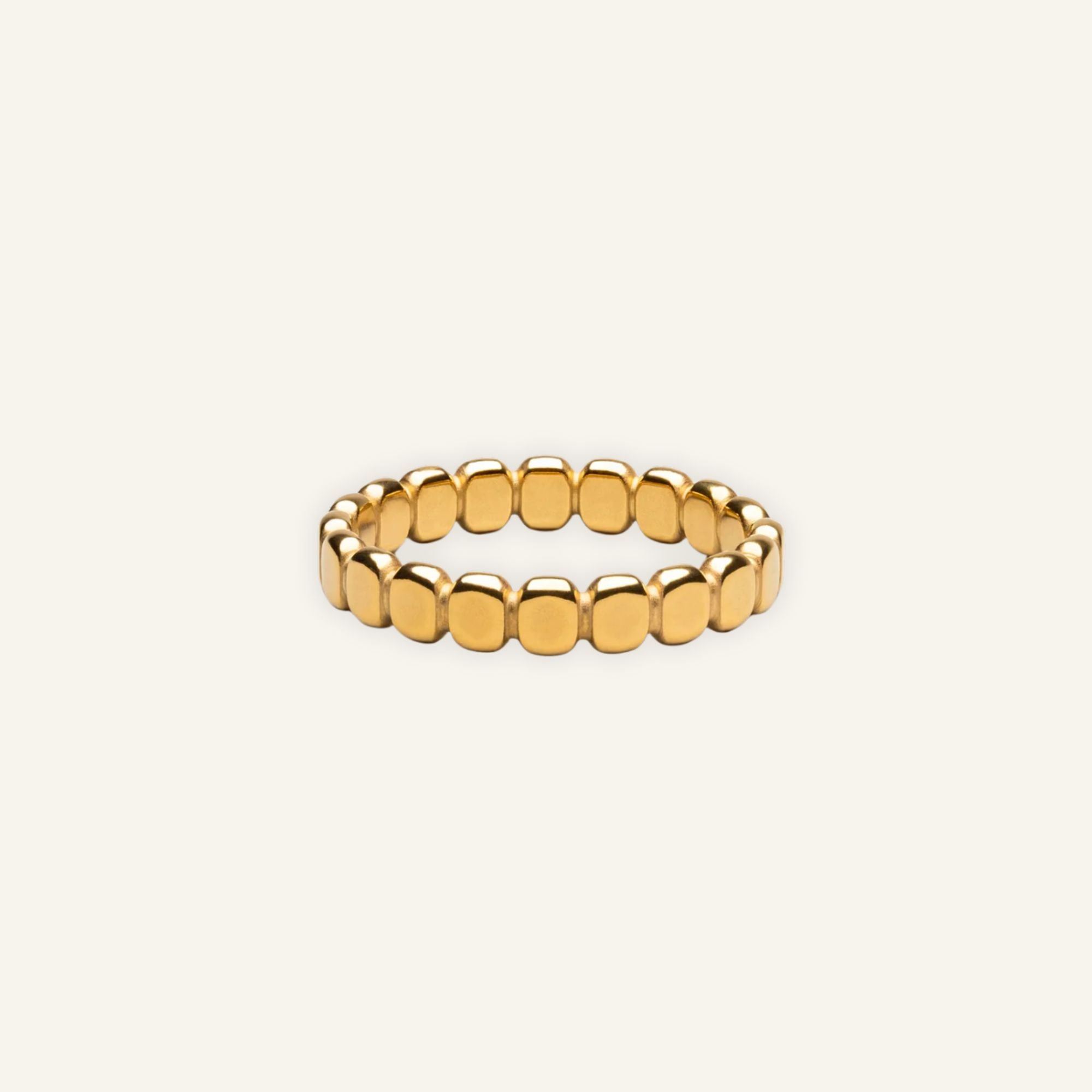 Delicate golden beads ring worn on hand, showcasing minimalist and elegant design.