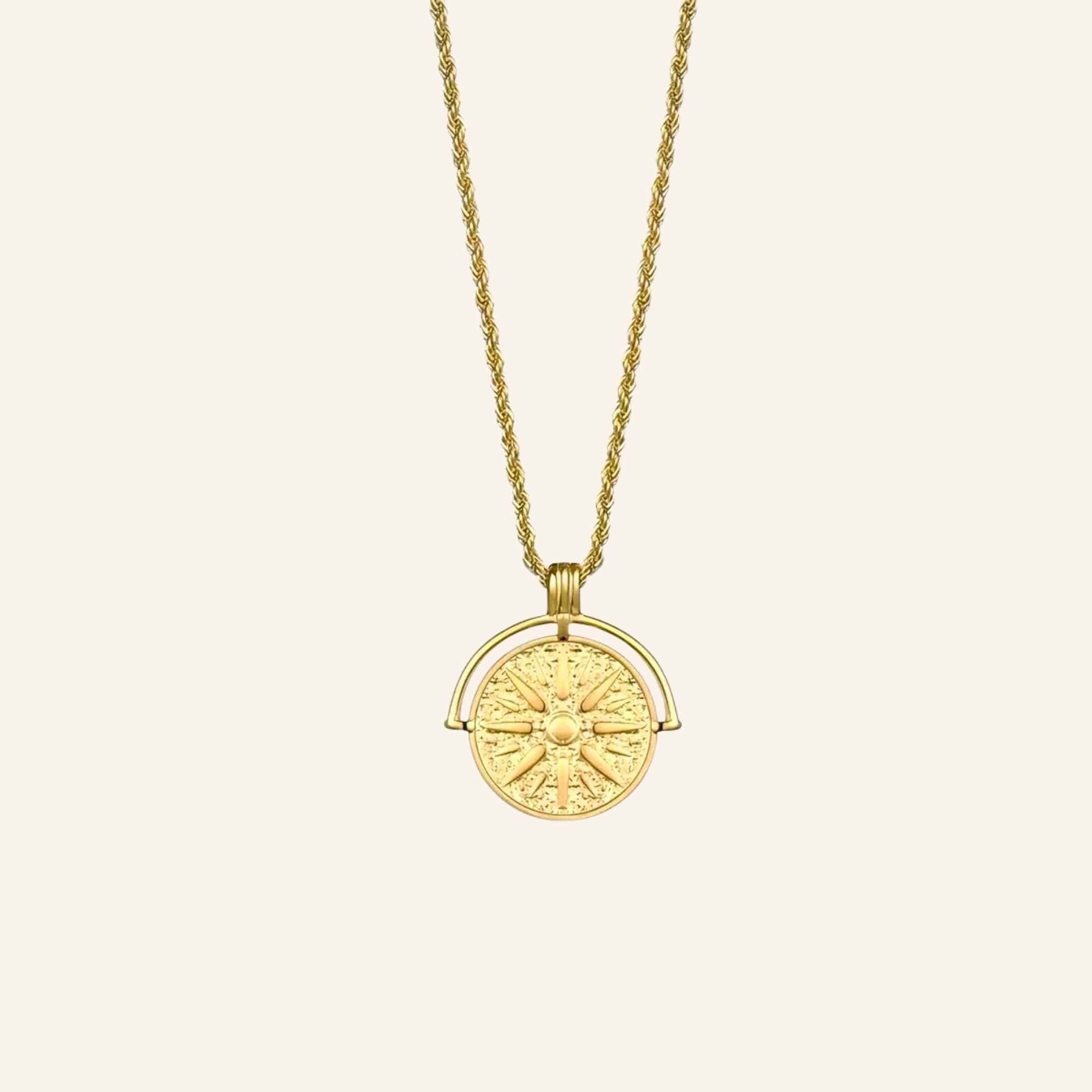 Helia Necklace in gold with rope chain and round sun medallion pendant.