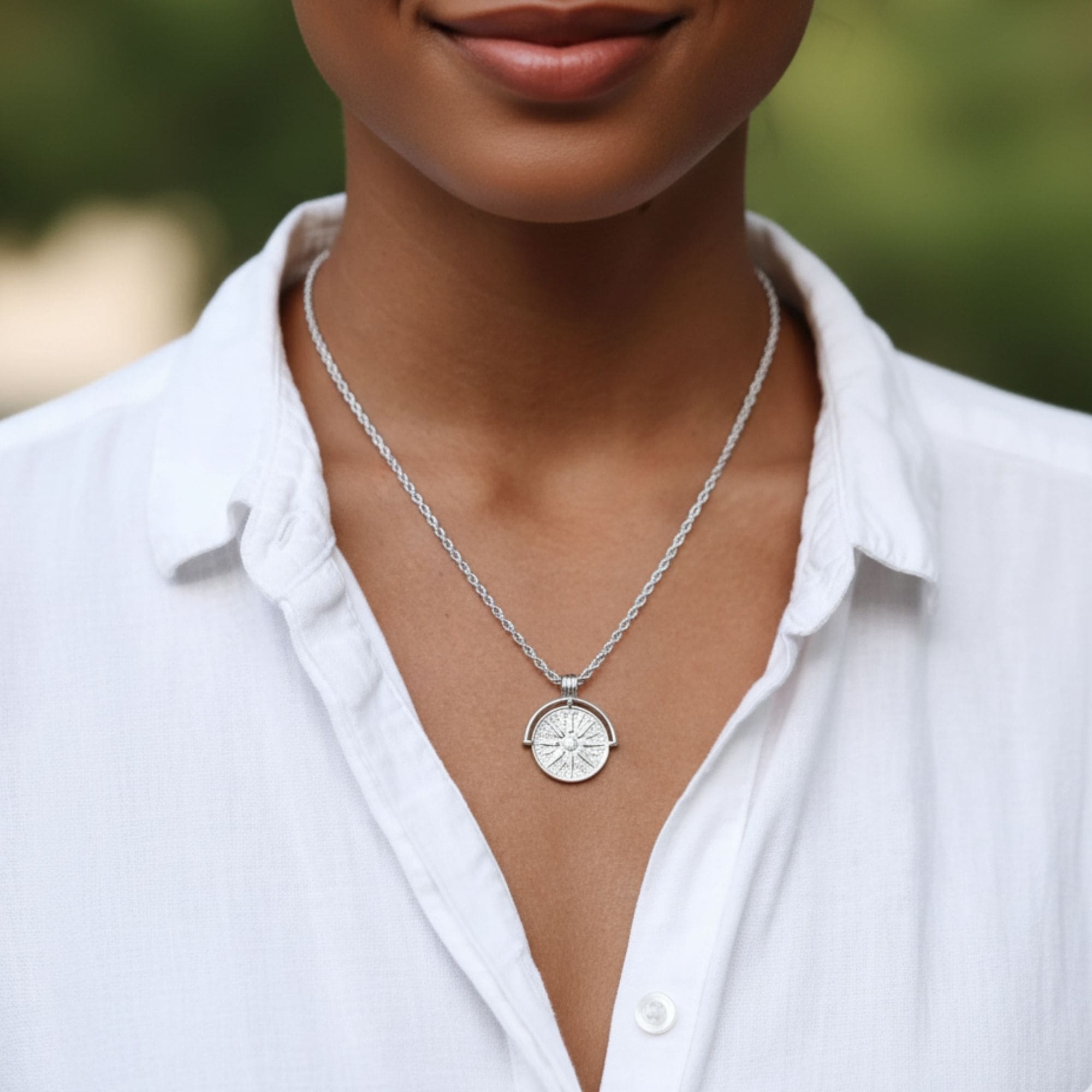 Helia Necklace in silver with sun medallion pendant on rope chain.