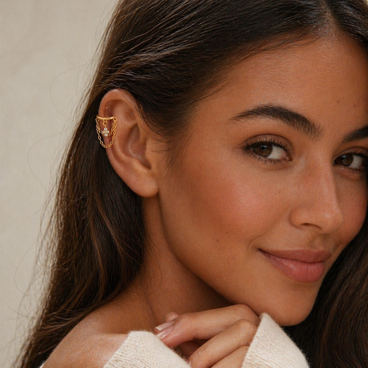 Woman wearing gold helix chain flower earring with CZ charm and layered chains on helix piercing