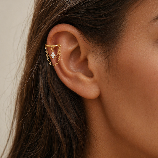 Gold helix chain earring with cubic zirconia flower charm and double chain detail on helix piercing