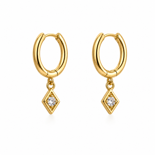 Gold huggie hoop earrings with kite-shaped zirconia charm, 925 sterling silver, on white background.