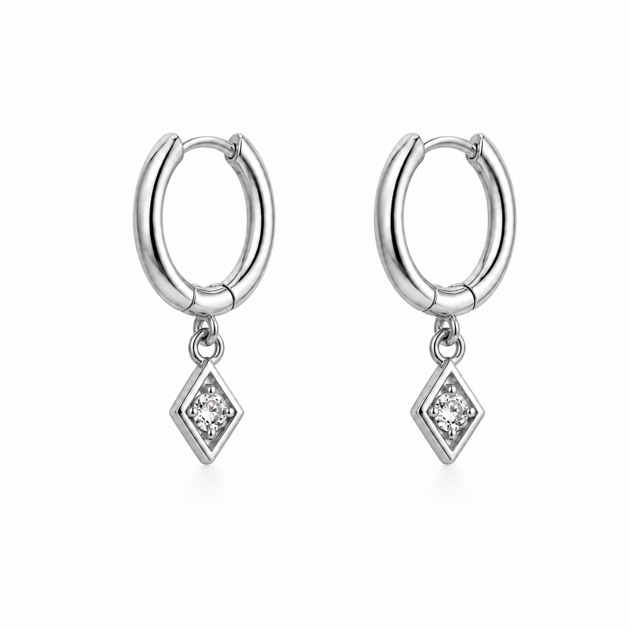 Silver huggie hoop earrings with kite-shaped zirconia charm, 925 sterling silver, on white background.