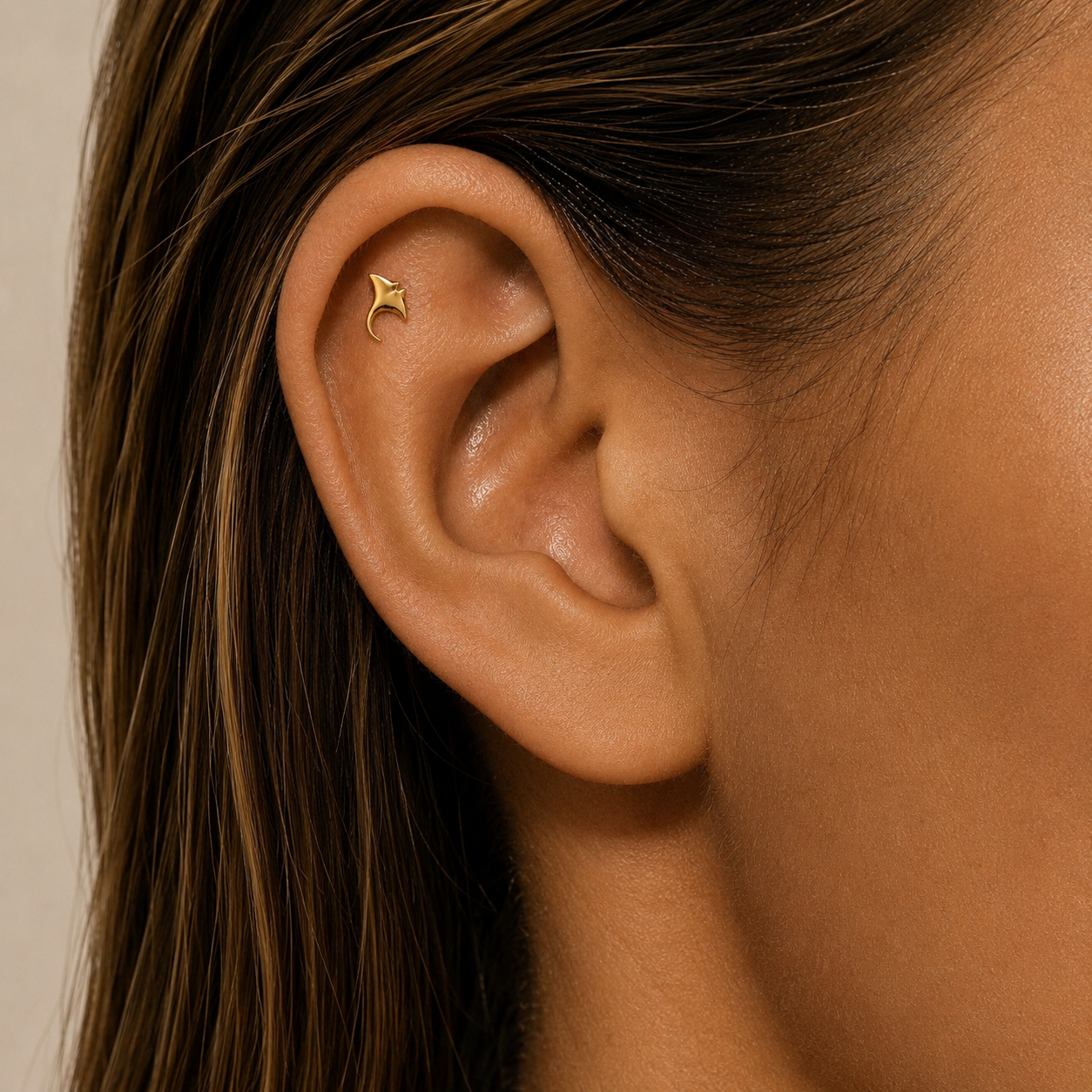 Minimalist manta ray cartilage earring worn on ear