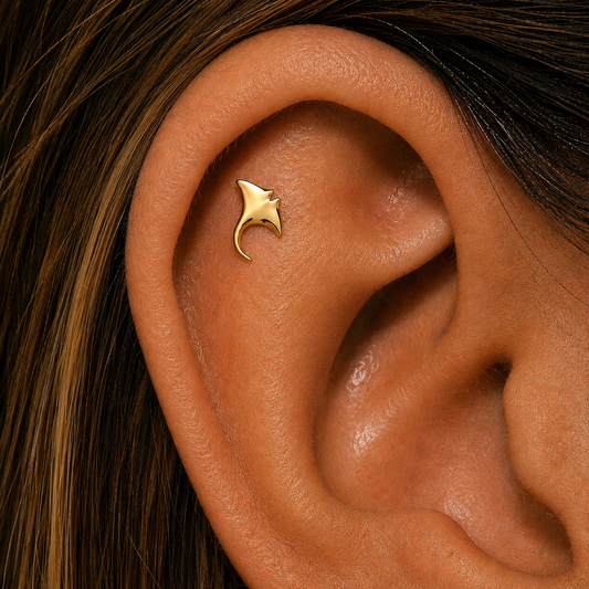 Gold manta ray helix piercing stud worn on cartilage ear piercing