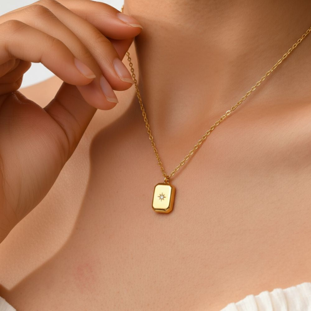 Mini star pendant necklace worn on chest, delicate gold necklace with cubic zirconia