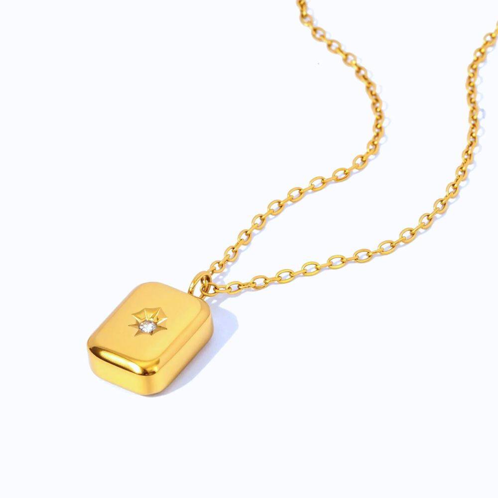 Mini star pendant necklace worn on chest, delicate gold necklace with cubic zirconia