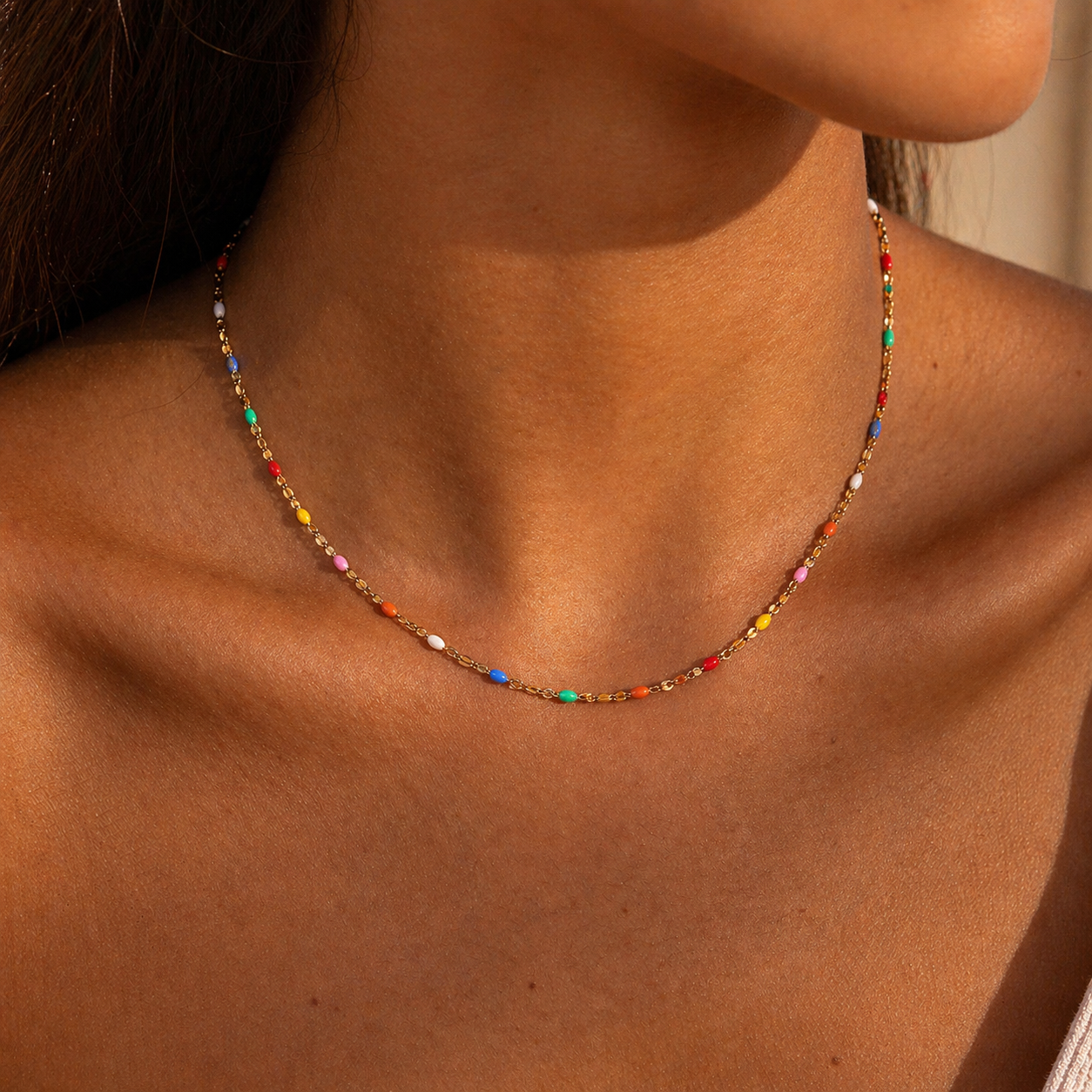 Close-up of multicolor beaded gold necklace, enamel chain necklace waterproof stainless steel jewelry