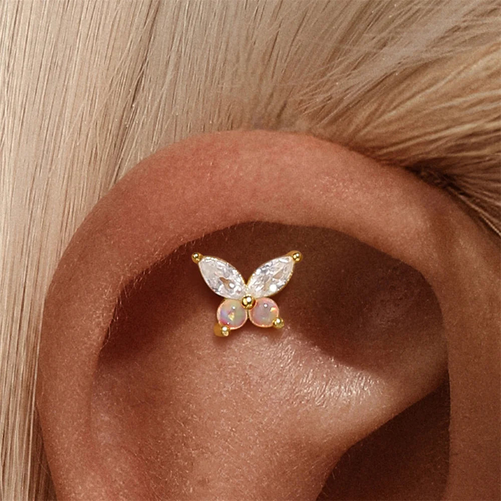 Opal butterfly stud earring worn on cartilage piercing in 925 sterling silver, delicate ear stack jewelry