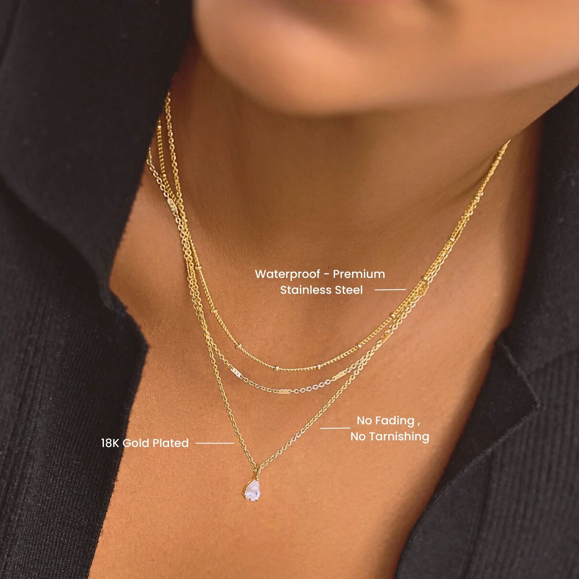Talia layered gold necklace with three delicate chains and teardrop pendant worn around the neck.