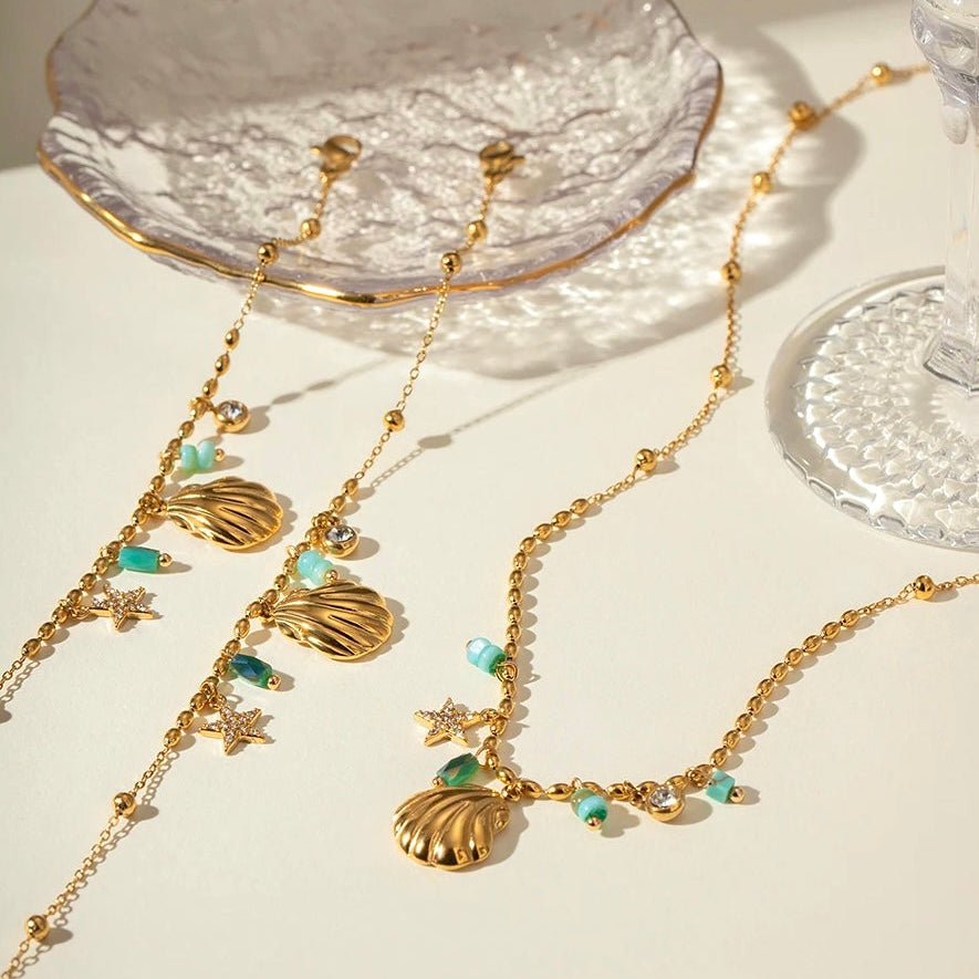 Coastal style jewelry set with gold shell charms, starfish, and turquoise accents