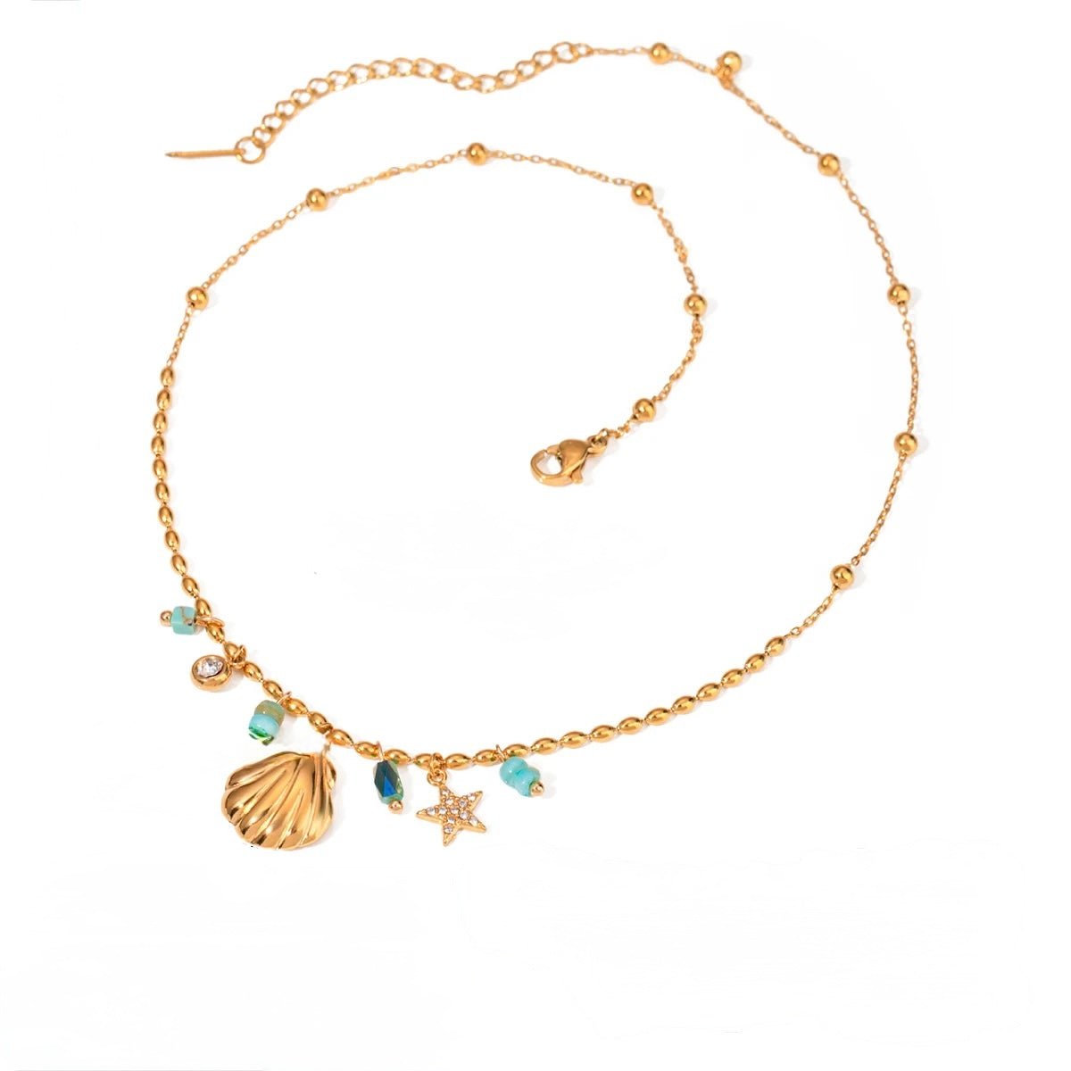 Gold necklace with shell charm, turquoise beads and star pendant on white background
