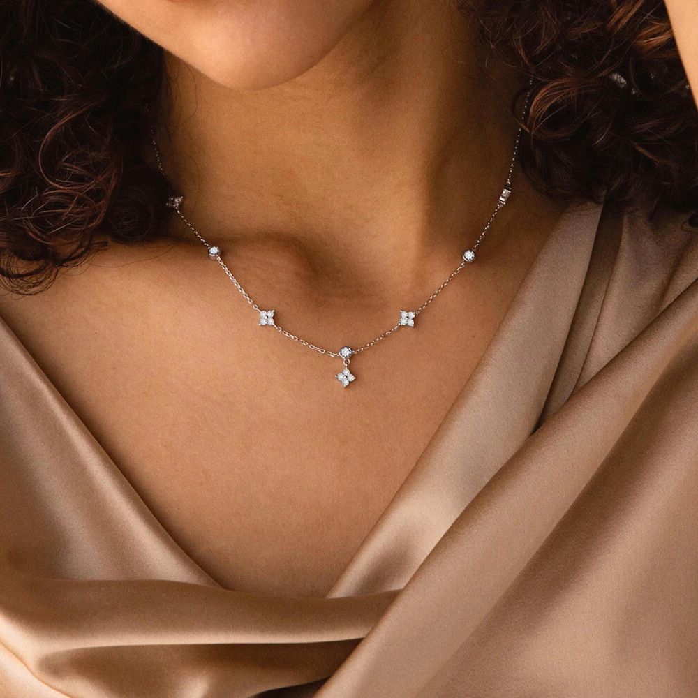 Model wearing silver daisy station necklace with sparkling zircon charms