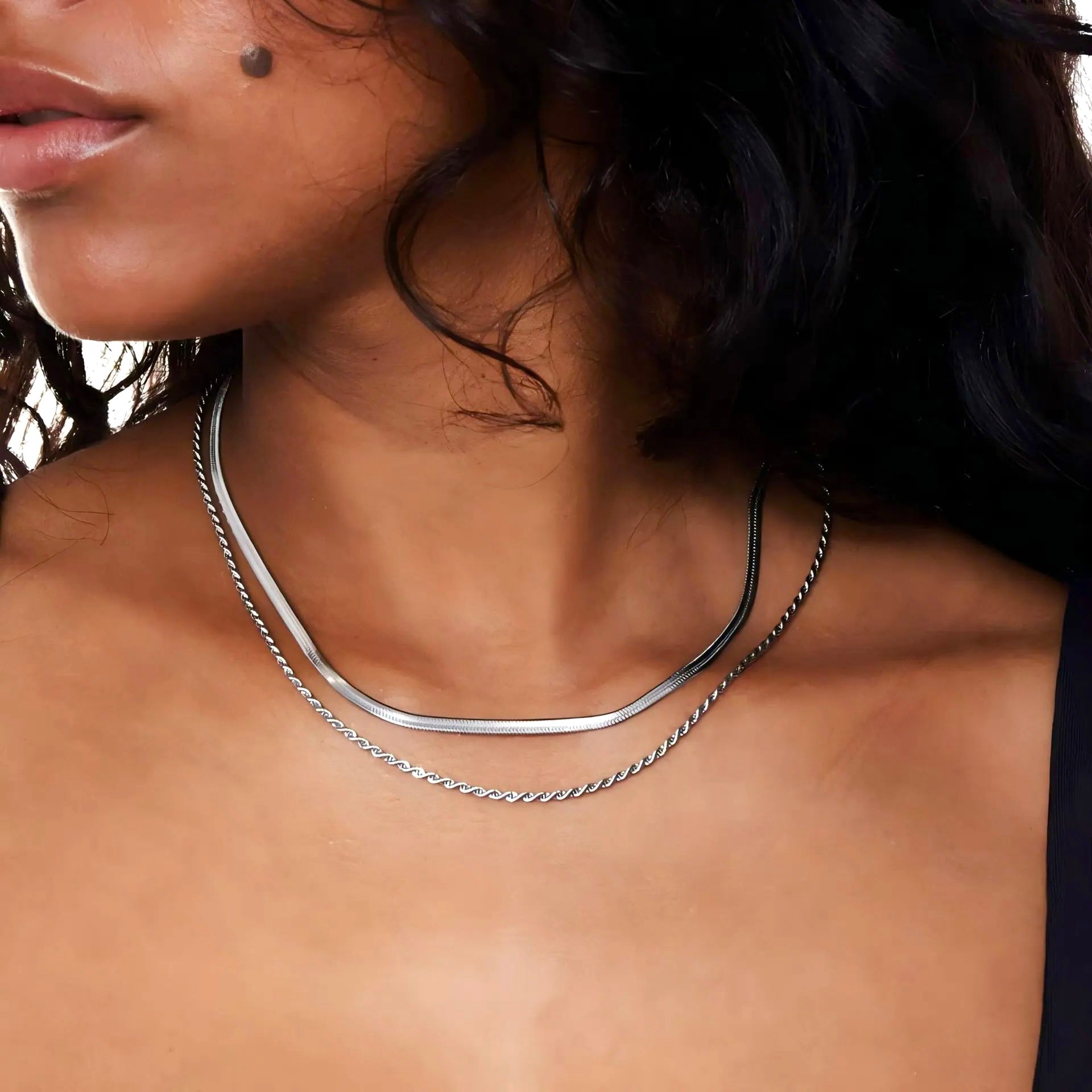 2-in-1 silver layered necklace worn by model with dark curly hair