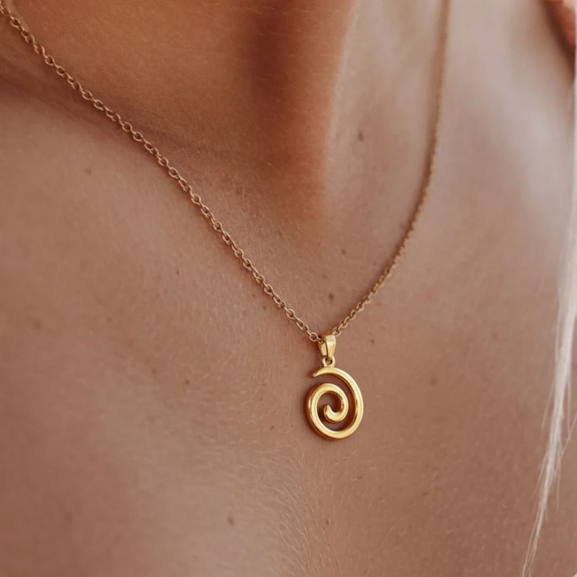 Gold swirl pendant necklace on model – minimalist 18K gold plated jewelry