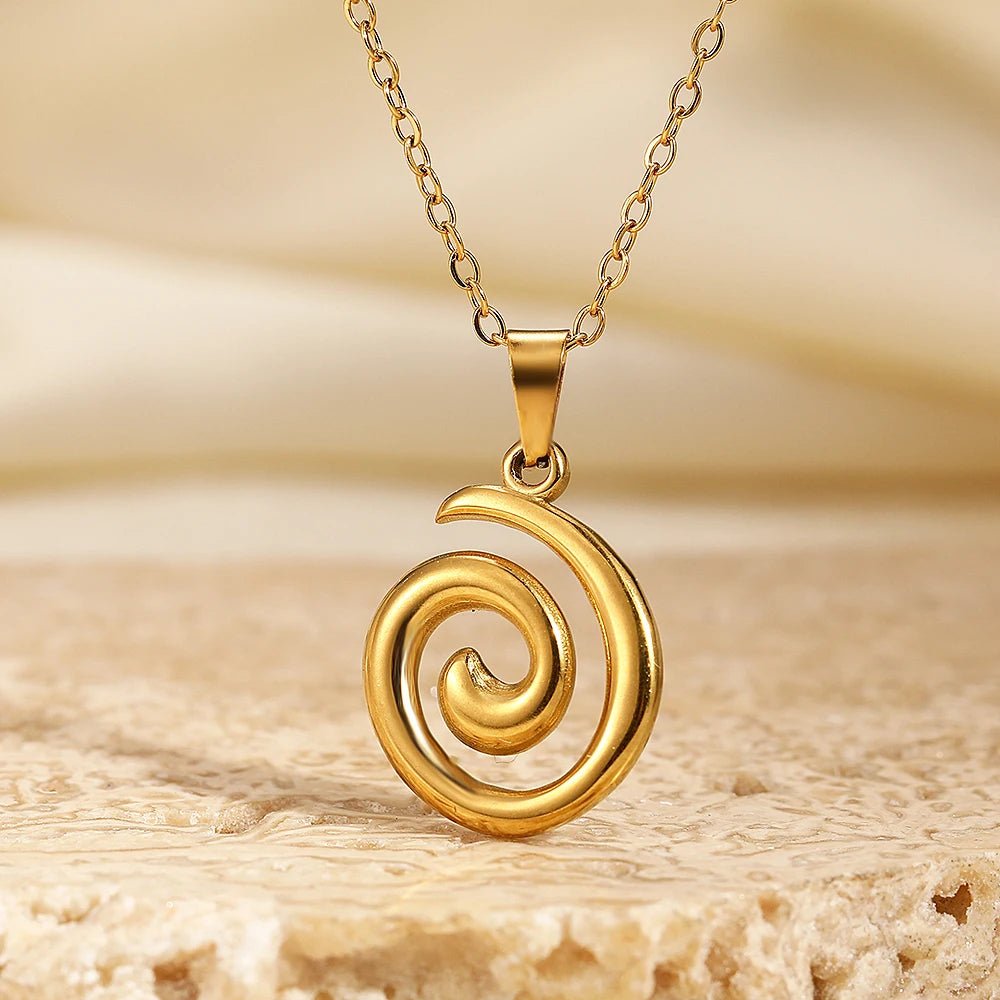 18K gold plated spiral pendant necklace on beige background – waterproof minimalist jewelry