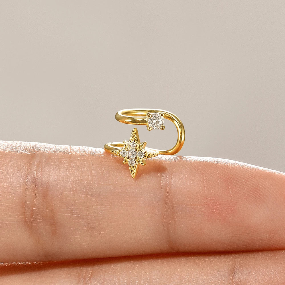 Gold star ear cuff no piercing shown on finger for size reference